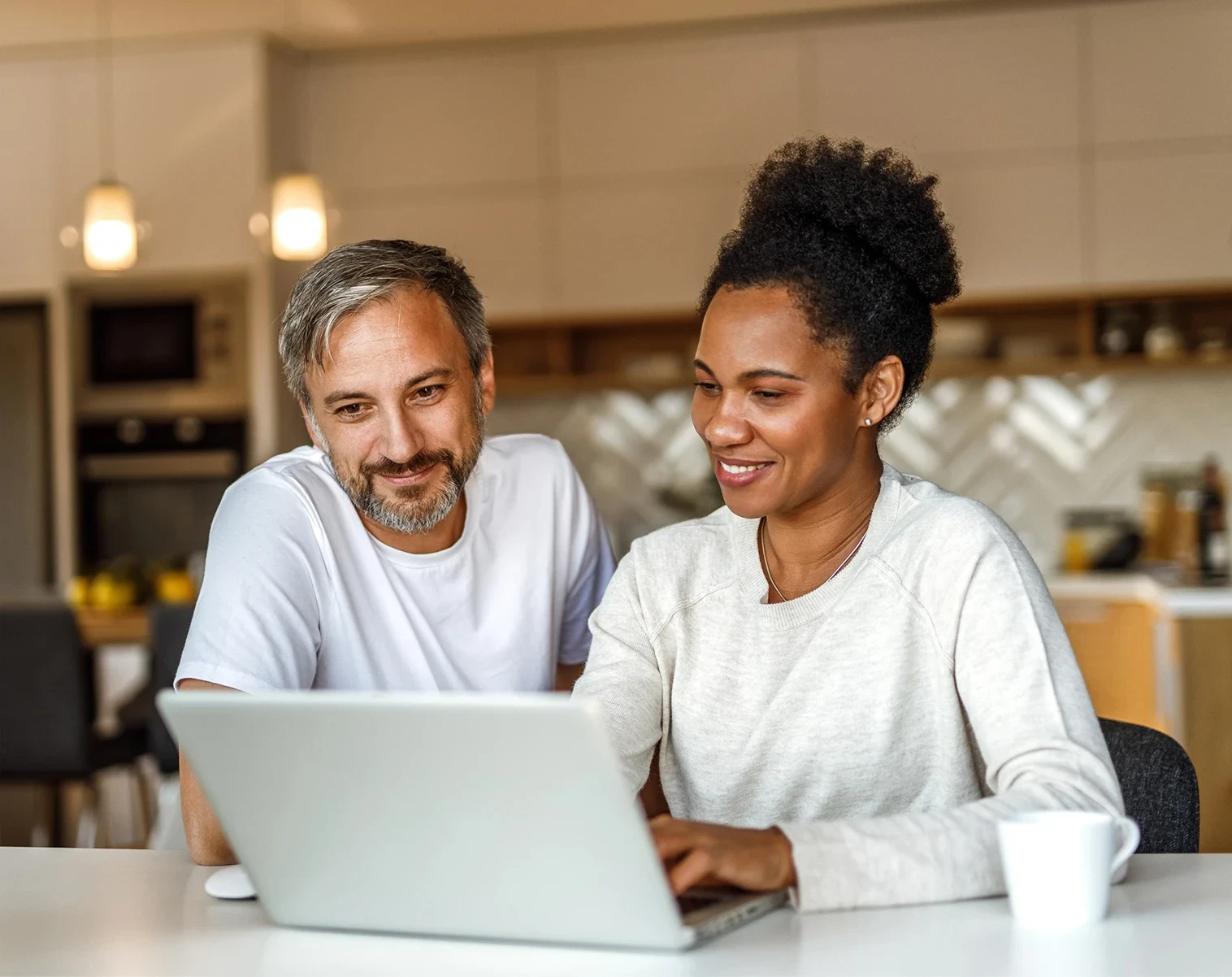 A man and women looking at a laptop together